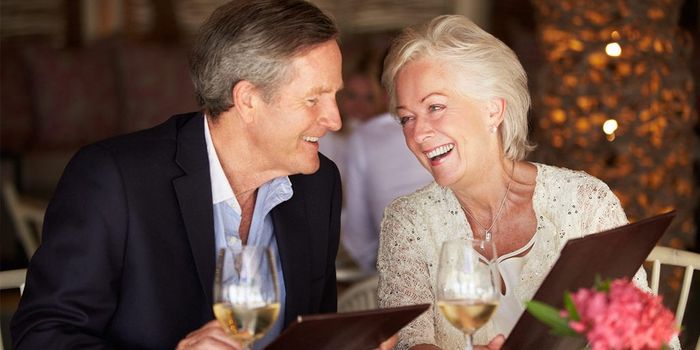 Smiling Old Couple In A Restaurant